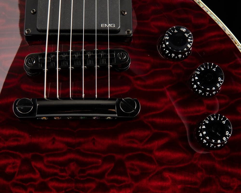 Close up of a red electric guitar.