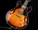 Yamaha SA2200-OVS Semi-Hollow guitar in Violin Sunburst color. Features include dual humbucker pickups, gold hardware, and a black pickguard. The body has a flamed maple top with f-holes.