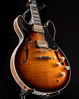 Yamaha SA2200-OVS Semi-Hollow guitar in Violin Sunburst color, featuring dual humbucker pickups, gold hardware, and f-holes, displayed on a stand.
