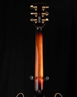 Yamaha SA2200-OVS Semi-Hollow guitar in Violin Sunburst. The image shows the back of the neck with a glossy finish and gold tuning pegs against a black background.