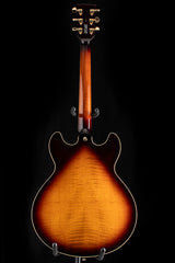 Yamaha SA2200-OVS Semi-Hollow guitar in Violin Sunburst. The back features a rich sunburst finish with a visible wood grain pattern. The neck is set-in with a glossy finish, and the headstock has gold tuning pegs.