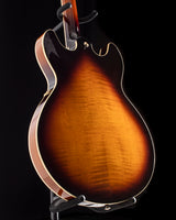 Yamaha SA2200-OVS Semi-Hollow guitar in Violin Sunburst, featuring a flamed maple back, gold hardware, and double cutaway design, displayed on a stand.