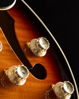 Close-up of a Yamaha SA2200-OVS Semi-Hollow guitar in Violin Sunburst. Features include gold control knobs and an f-hole on the body.