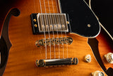 Close-up of a Yamaha SA2200-OVS Semi-Hollow guitar in Violin Sunburst. Features include a glossy finish, dual humbucker pickups, a tune-o-matic bridge, and a black pickguard.