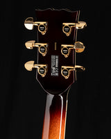 The back of a Yamaha SA2200-OVS Semi-Hollow guitar in Violin Sunburst. It features gold tuning pegs and a glossy finish on the headstock.